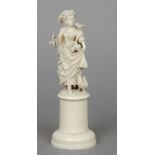 A 19th century Dieppe carved ivory figure
Modelled as a young lady feeding birds, standing on a