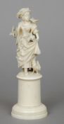 A 19th century Dieppe carved ivory figure
Modelled as a young lady feeding birds, standing on a