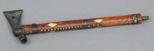 An American Indian pipe
The bone inlaid and brass studded shaft with an axe head and pipe bowl.