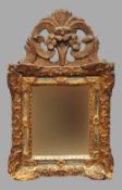 An 18th century Dutch giltwood framed mirror
The rectangular plate within mirrored border and carved