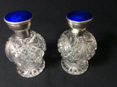 A pair of George V silver mounted enamel decorated cut glass perfume bottles, hallmarked