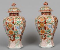 A pair of Japanese Imari baluster vases and covers
Of hexagonal form and typically decorated.  40 cm