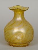 A Loetz Art Glass vase
With wavy rim, pinched body and allover iridescence in yellows and golds.