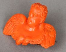 A 19th century unmarked gold mounted coral brooch
Carved as the bust of a cherub.  4.5 cm wide.