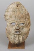 A terracotta tribal mask
Of human form, mounted on a display stand.  23 cm high. CONDITION
