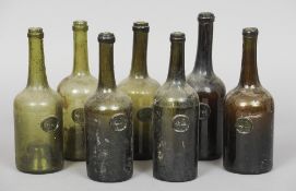 Seven 18th/19th century sealed All Souls college green and brown glass wine bottles
Each with All