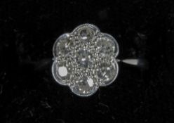 A diamond set 18 ct white gold and platinum daisy ring
In fitted case. CONDITION REPORTS: