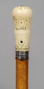 An 18th century malacca cane
With white metal collar initialled SB and turned ivory handle with