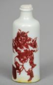 A Chinese porcelain snuff bottle
Iron red painted with a warring figure and stylised bats, blue