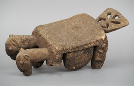 An African carved ceremonial stool
Worked as a twin headed beast with fan tail.  43 cm long.