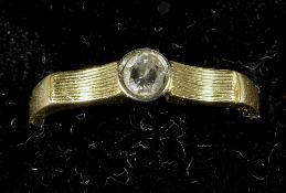A diamond set yellow metal solitaire ring
The stone approximately 1/8th carat. CONDITION REPORTS: