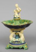 A 19th century Majolica centrepiece
The dished upper section surmounted with bacchic putto.  31 cm