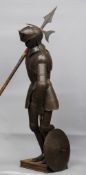 A 19th century German etched steel suit of armour
The helmet with hinged visor and full body armour,