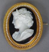 A fine quality Victorian high relief hardstone carved cameo brooch
In enamel decorated gold frame,