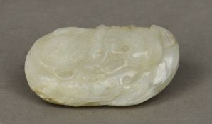 A Chinese carved jade pebble
Worked with a mythical beast.  7 cm wide. CONDITION REPORTS: