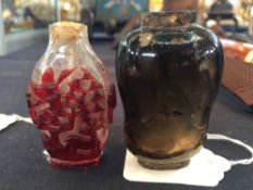 A small Chinese snuff bottle
Of vase form, with twin mask handles carved with various animals