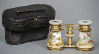 A pair of gilt metal and enamel decorated opera glasses
Painted with a rural couple at rest, cased.