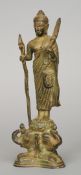 An antique Southern Indian patinated bronze model of a deity
Standing holding a staff above three