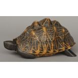 A tortoiseshell box
Naturalistically modelled as a tortoise, the interior with specimen wood inlays.