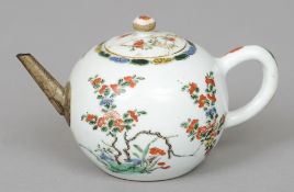 An early 18th century Chinese Export famille verte teapot
The squat globular body decorated in