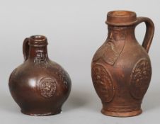 A 16th/17th century Frechen style Bartmann or Bellarmine jug
With applied heraldic roundels;
