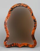 An Art Deco tortoiseshell veneered dressing mirror
The shaped plate with easel support.  42 cm high.