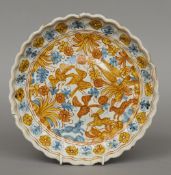 An Italian Maiolica footed dish
The scalloped rim with floral border, the centre painted with hares,