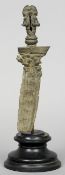 An ancient sword fragment
The handle cast as two figures standing back to back, the blade base