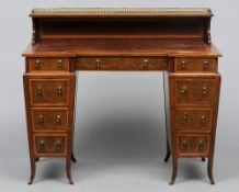 An Edwardian inlaid mahogany pedestal desk, stamped Edwards & Roberts
The leather inset shaped