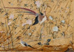 A Chinese embroidered silk bedspread
The peach ground decorated with various birds and insects