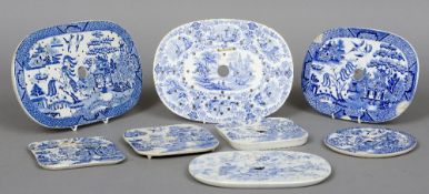 Eight various blue and white drainers  
Variously decorated.  The largest 31 cm long.  (8) CONDITION
