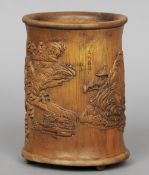A Chinese carved bamboo brush pot
Carved in the round with figures and pagodas amongst a