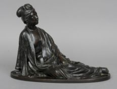 A Meiji period Japanese bronze figure
Modelled as a reclining female in loosely fitting robe, on