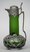 A Continental Art Nouveau Art metal mounted green glass ewer
Worked overall with organic scrolls.