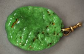 A carved jade pendant
Worked with monkeys.  5 cm long. CONDITION REPORTS: Generally in good