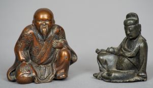 A Chinese bronze figure
Modelled as a seated scholar holding a scroll; together with another Chinese