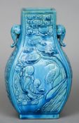 A Chinese moulded pottery twin handled vase
With allover turquoise glaze, the handles elephant