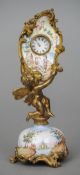 An enamel decorated ormolu desk timepiece
Formed as a cherub, holding an inlaid panel with inset