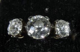 A diamond set white metal three stone ring
The central stone approximately 0.75 carat. CONDITION