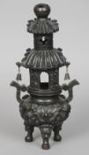 A late 19th century Chinese patinated bronze censor
Of pagoda form with twin scrolling handles,