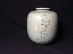 A Korean pottery vase
Typically decorated with cranes and foliate scrolls, on a celadon glaze, two