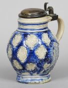 A 17th century Westerwald stoneware jug
Typically decorated and with hinged metal cover and thumb