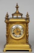A small 19th century gilt bronze mantel clock
The finial mounted stepped top above a silvered dial