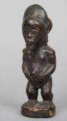 A carved African tribal figure
Modelled naked with a goatee beard.  21 cm high.  CONDITION