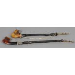Two 19th century Continental white metal and horn mounted Meerschaum pipes
One worked with a