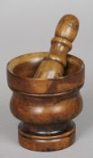 A 18th/19th century beechwood mortar together with a fruitwood pestle
The mortar 12 cm high.  (2)