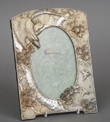 A Meiji-Taisho period Japanese unmarked silver picture frame
Worked with an eagle worrying two