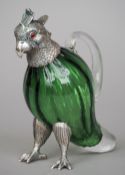 A white metal mounted green glass jug
Formed as a parakeet.  16 cm high. CONDITION REPORTS: