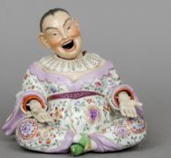 A 19th century Chinese porcelain nodding figure
Typically modelled seated in floral robes with a