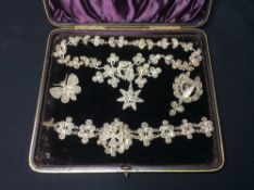 A Victorian mineral set unmarked white metal suite of jewellery
Comprising: necklace with pendant,